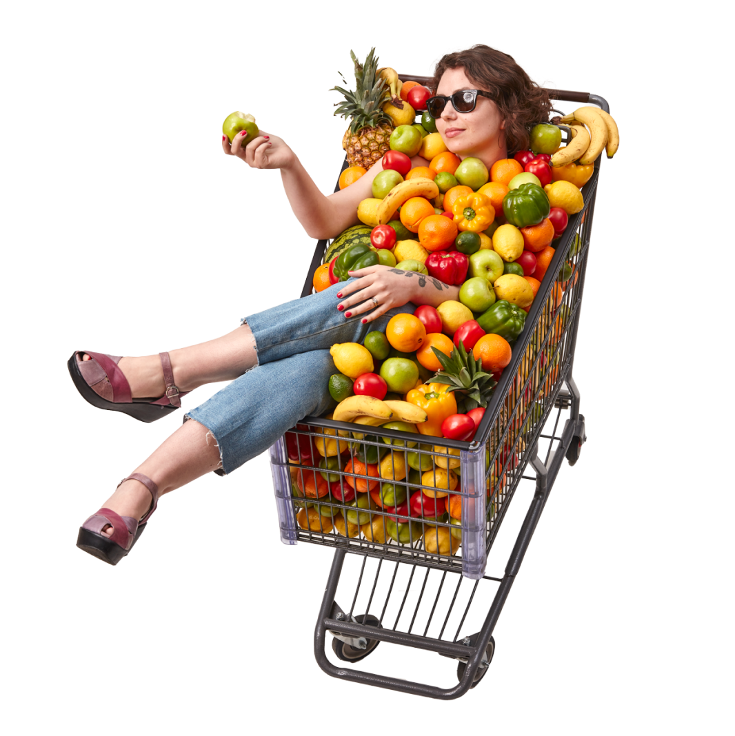 Woman in shopping cart full of produce