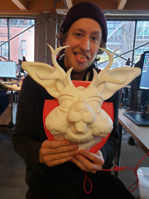Pollinate employee with a mounted Jackalope sculpture