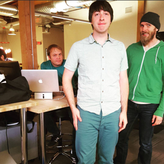 Pollinate developers standing in front of a desk for a photo